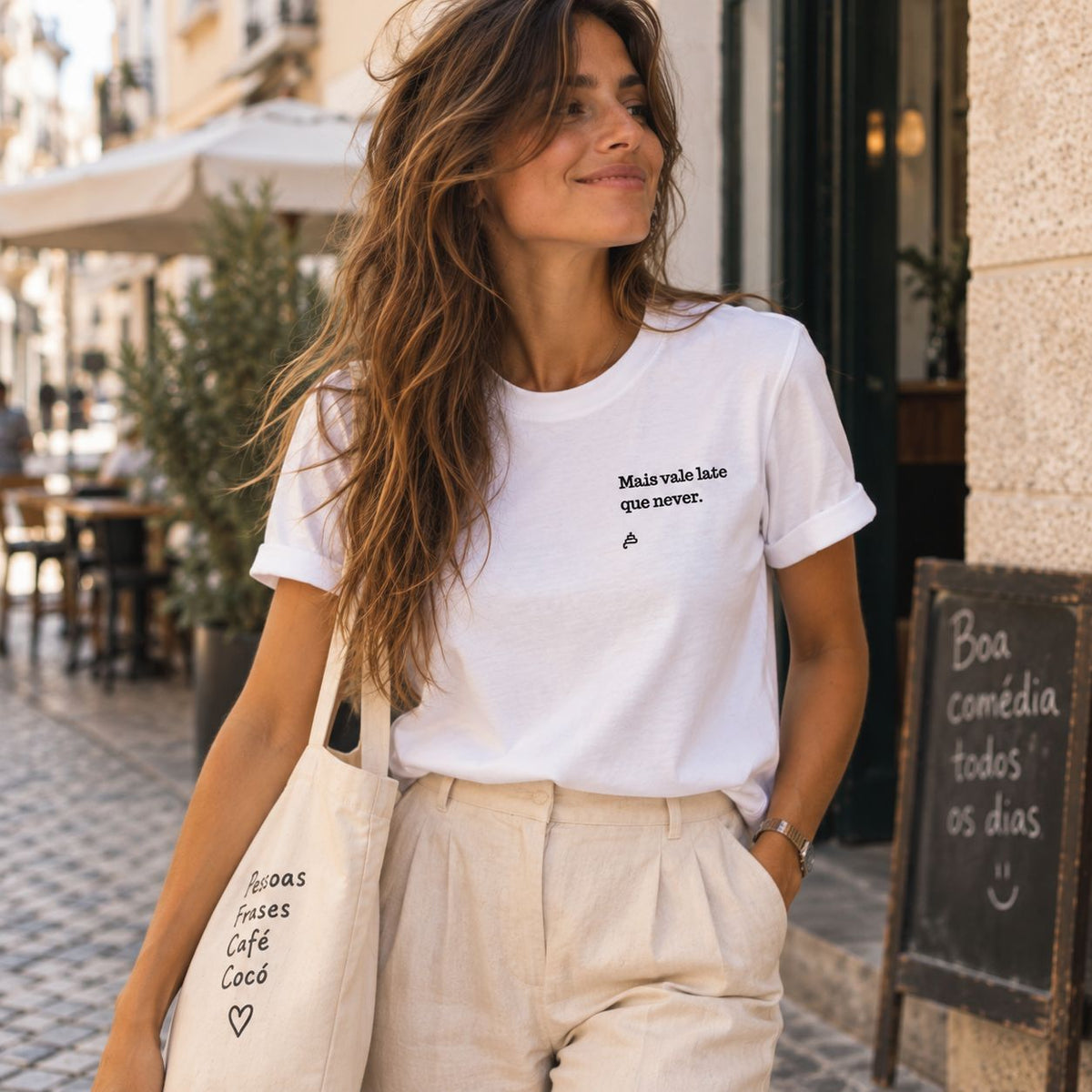 Mulher com T-shirt branca bordada com a frase “Mais vale late que never” da Poesia Cocó